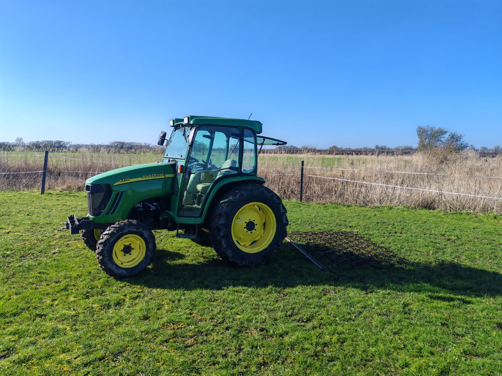 MES Rural compact tractor grass harrowing a paddock in Lincolnshire